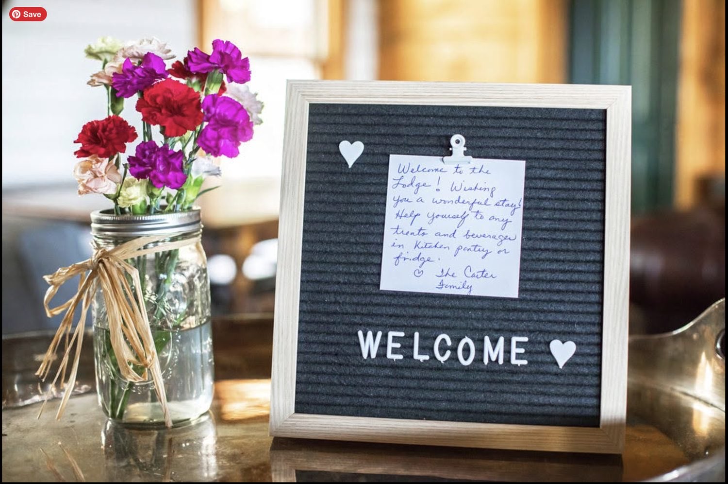 A welcome note on the letter board, with roses