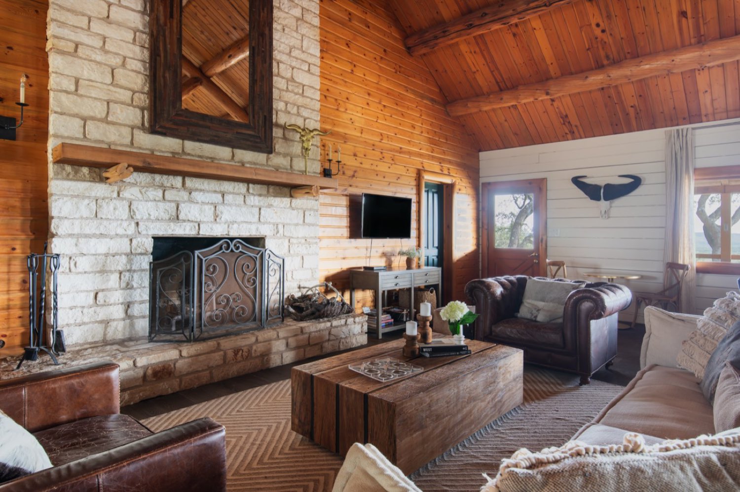 Stone fireplace and leather sofas