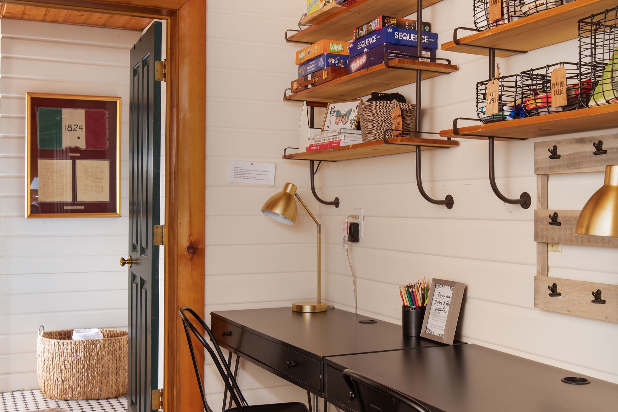 The games nook — board games, art supplies, and a shared desk