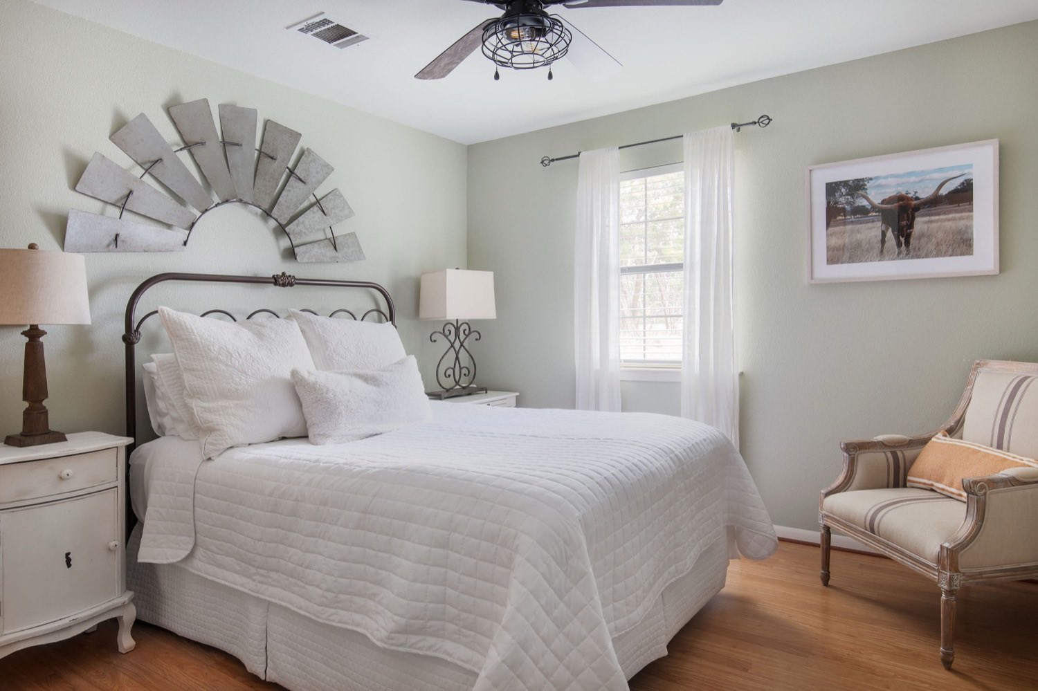A bedroom with a windmill headboard