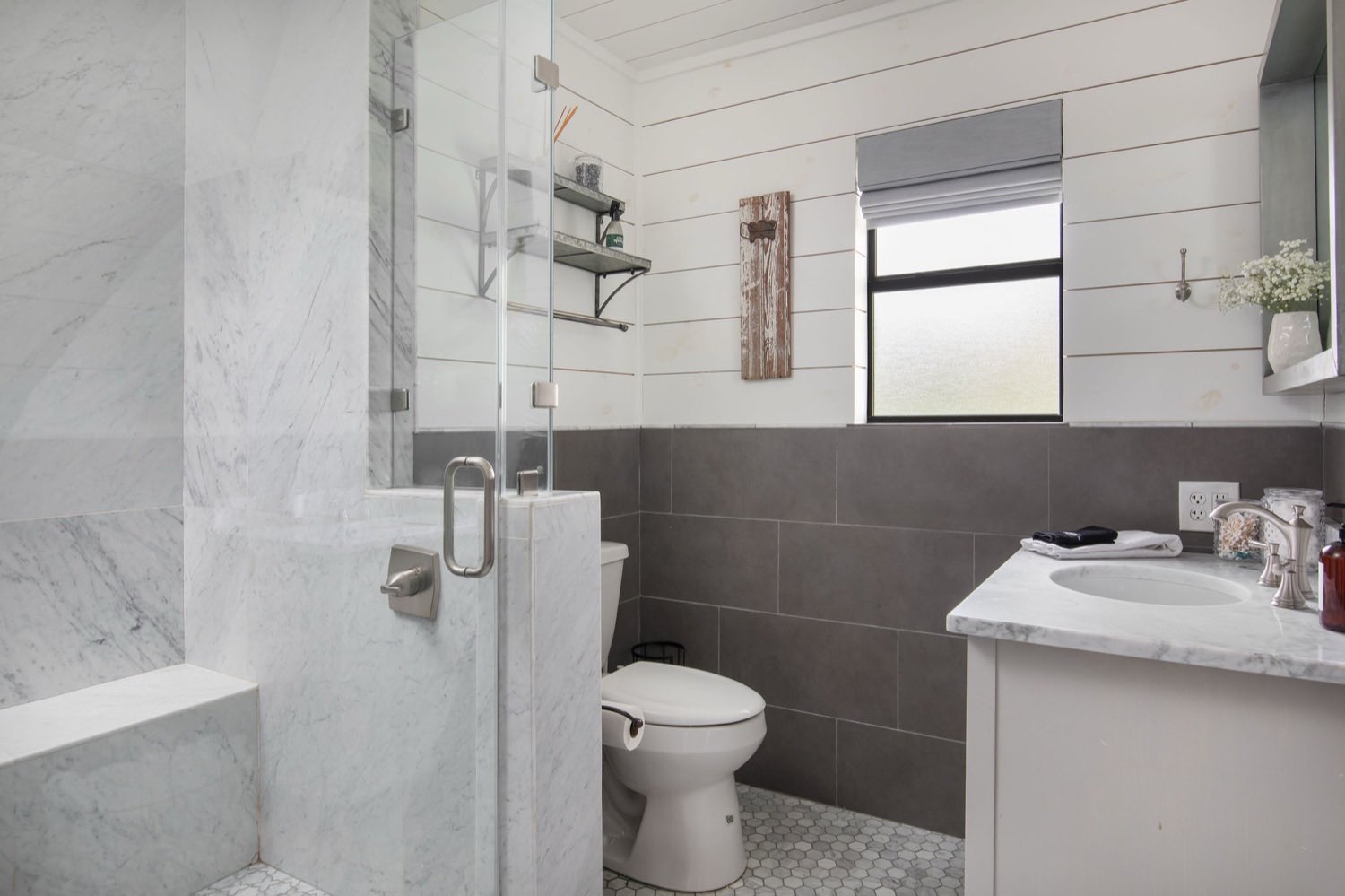 A marble bath with a walk-in shower