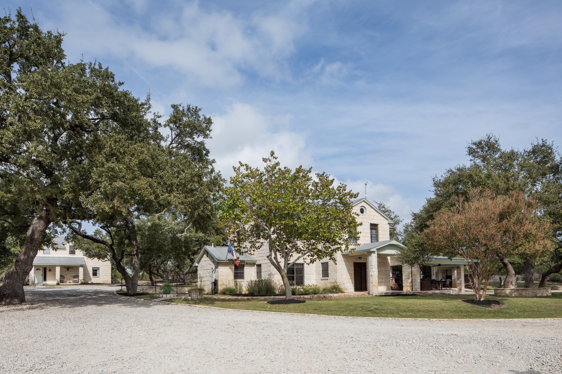 The whole ranch at Wimberley Valley Lodge — two homes, the bunkhouse, and the party barn